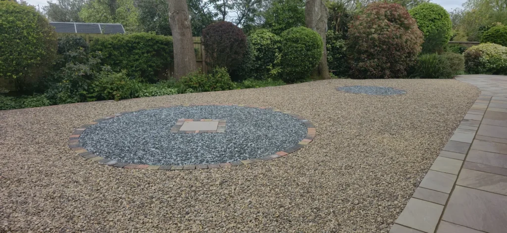 Large gravel garden with a circular feature of blue-grey chippings, Weston Favell