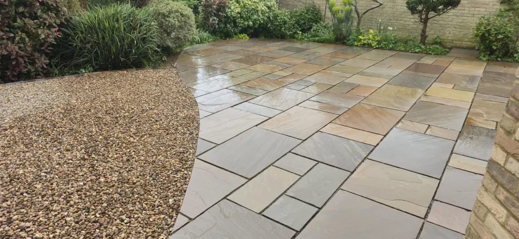 Autumn Brown Indian sandstone patio curving into a gravel garden in Weston Favell, Northampton