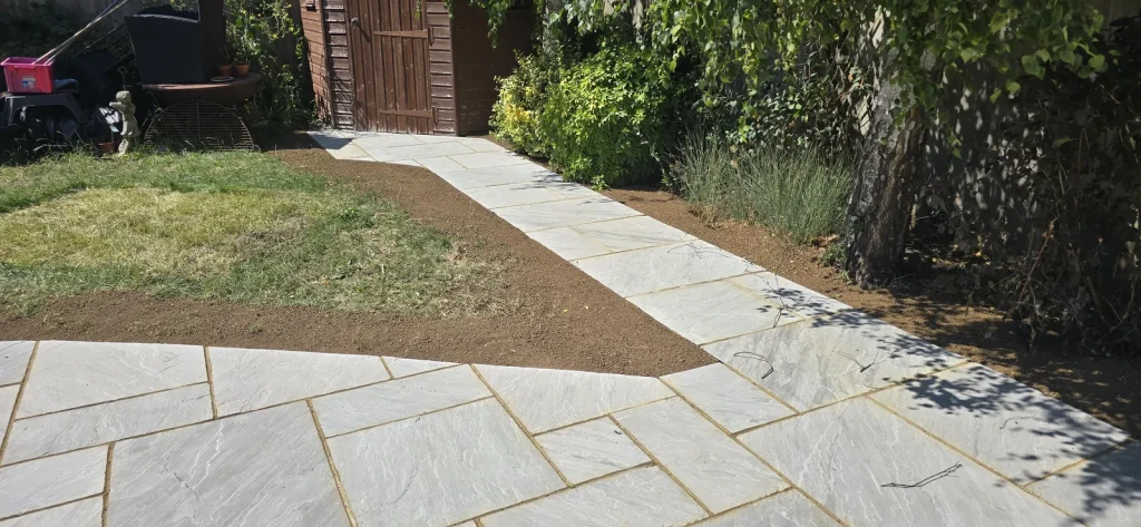 Sandstone path leading from the patio down the side of the garden