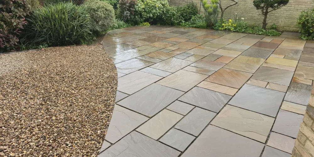Autumn Brown Indian sandstone patio curving into a gravel garden in Weston Favell, Northampton