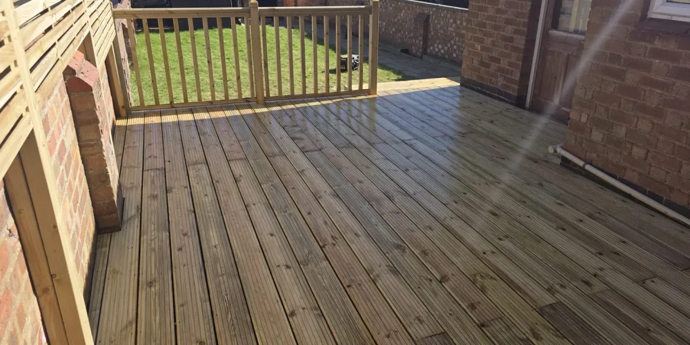 Timber decking with slatted privacy screens and a spindle balustrade in Abington, Northampton